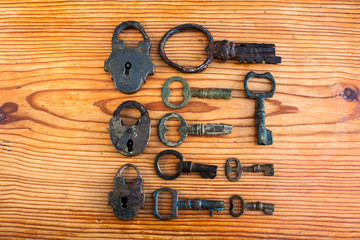 An interesting set of vintage keys on a wooden background