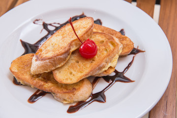 hot french toast with chocolate sauce and cherry