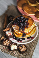 Picture of few pancakes with blackberries and sugar