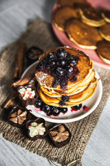 Picture of few pancakes with blackberries and sugar