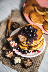Picture of few pancakes with blackberries and sugar