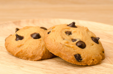 Chocolate chip cookies on wooden background