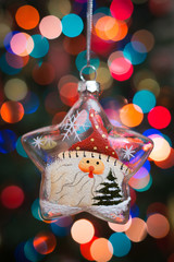 Christmas Ornament with Lighted Tree in Background