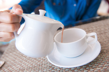 pouring coffee into coffee cup