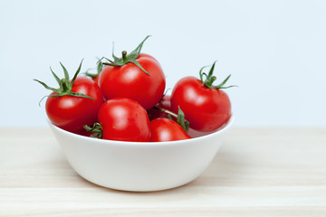red tomatoes on wooden table