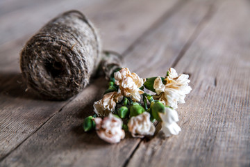 Faded carnations with old scissors and old thread, vintage