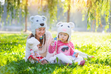 mother and daughter in a park wearing a knit hat