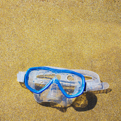 diving mask on a golden beach