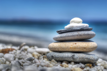 stones pile on white pebbles by the shore