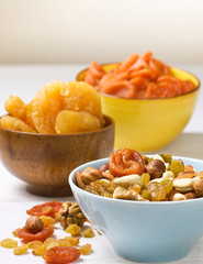 nuts and dried fruits on wooden background