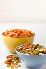 nuts and dried fruits in a blue cup