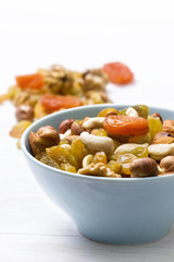 nuts and dried fruits in a blue cup