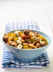 nuts and dried fruits in a blue cup