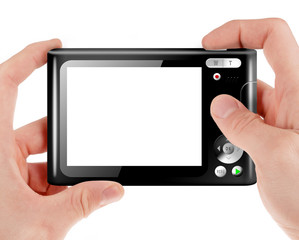 Hand holding a compact digital camera with empty LCD screen