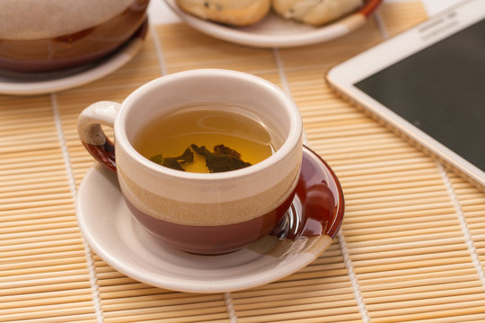 cup of organic chinese tea  with tablet computer
