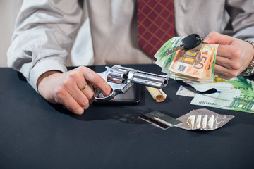 Loan shark with gun, money, drugs