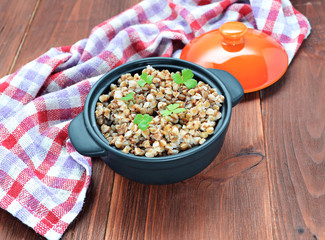 Buckwheat groats in a wooden table