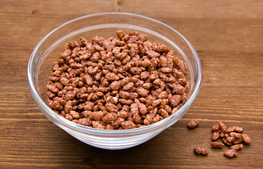 Rice cereal on bowl on wooden table