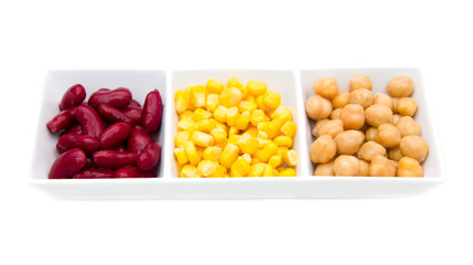 Tris of cooked vegetables on white background