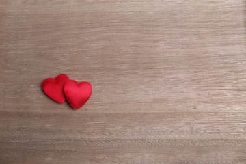 two red hearts on a wooden background