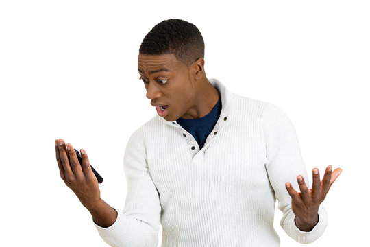 young man shocked surprised by what he sees on cell phone