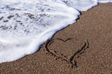 heart on sea sand