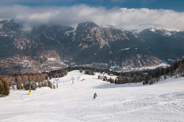 Scenic view of snowy slope in ski resort.