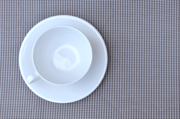 white cup on a grey napkin background texture