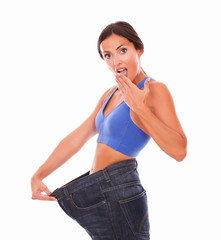 Sporty young woman looking surprised on body shape