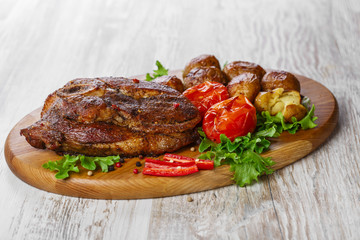 roasted pork shoulder on the bone with potatoes