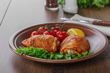 baked chicken thigh with cherry tomatoes and lemon