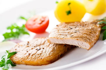 Fried steaks, boiled potatoes and vegetable salad