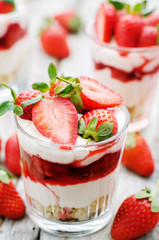layered dessert with strawberries, biscuit cake and cream cheese