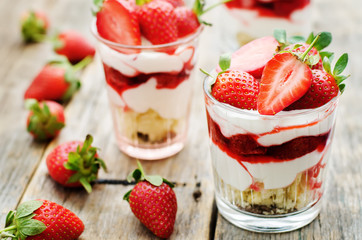 layered dessert with strawberries, biscuit cake and cream cheese