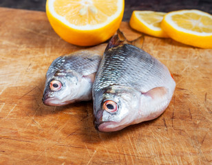 Raw fish with lemon on the cutting board