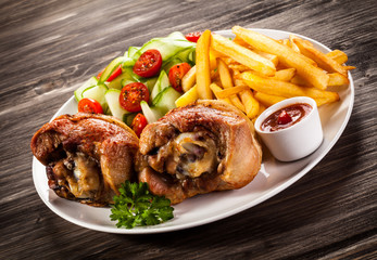 Grilled turkey legs with chips and vegetables