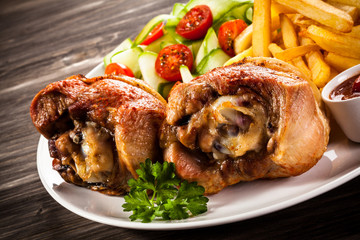 Grilled turkey legs with chips and vegetables
