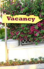 Signboard with text Vacancy near hotel