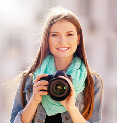 Young photographer taking photos outdoors