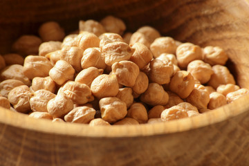Chickpeas in a wooden bowl, close-up