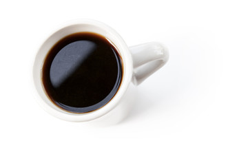 White cup full of black coffee stands on table
