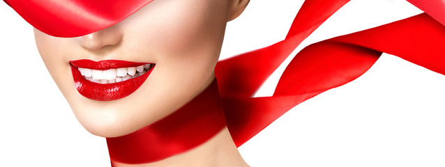 Beautiful model girl with red lips and blowing red silk scarf