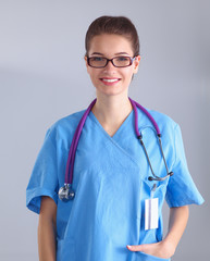 Portrait of young woman doctor standing in hospital