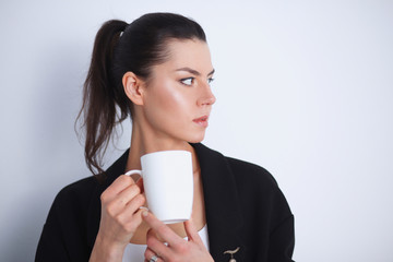 Young woman holding a mug, isolated on white background
