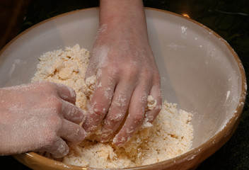 Childs hands rubbing flour and other ingredients