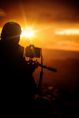 Naklejka premium Taking Pictures at Sunset