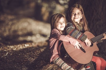 Obraz na płótnie Canvas Young Girls Playing Guitar