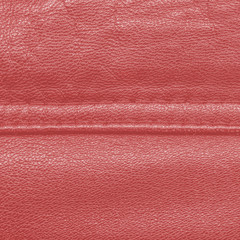 Fototapeta premium red leather texture, seam. Useful as background