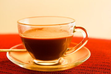 Cup of coffee on the table in red.