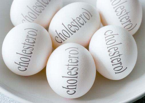 White eggs with Cholesterol text - health and healthy lifestyle